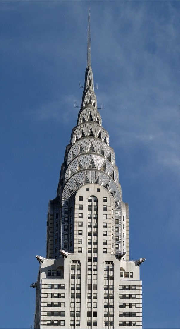 The stainless steel Art Deco spire of the Chrysler Building in New York with stepped sunburst arches