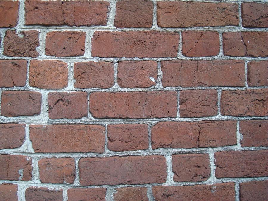 Historic brick wall laid in Flemish bond with alternating headers and stretchers