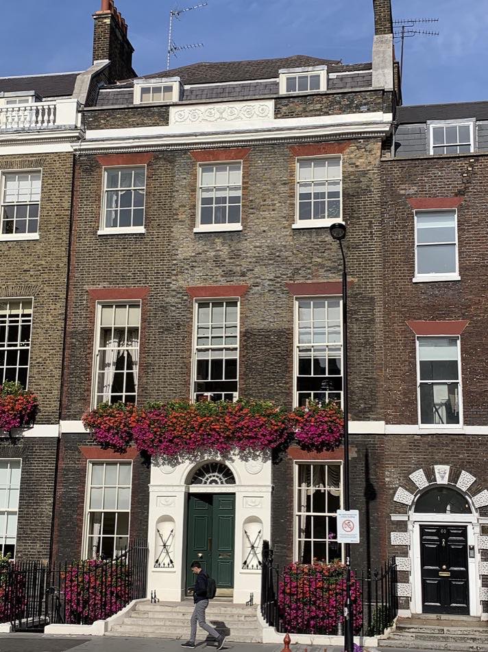 Georgian townhouse façade with sash windows, a cornice, stringcourses, and a classical entrance