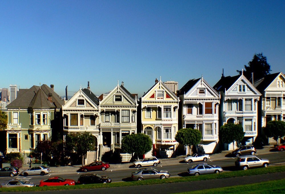 Colorful Victorian-era houses with bay windows, steep roofs, and ornate façades in San Francisco