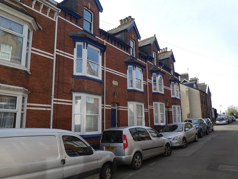 A row of red-brick Victorian terrace houses in Exeter